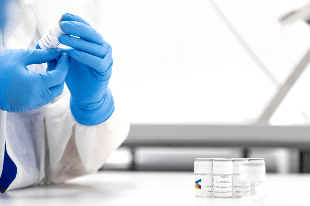 Singota team member applying label to vial
